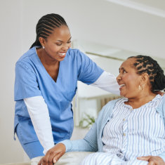aide smiling at the senior woman