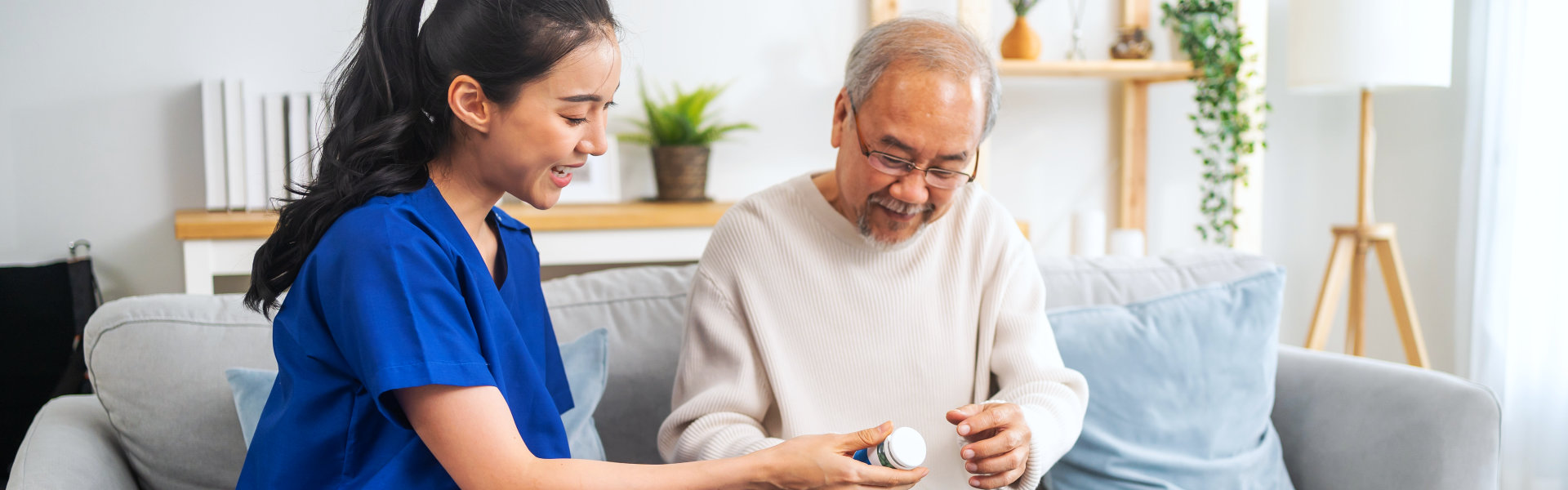 aide assisting the senior man on his medication