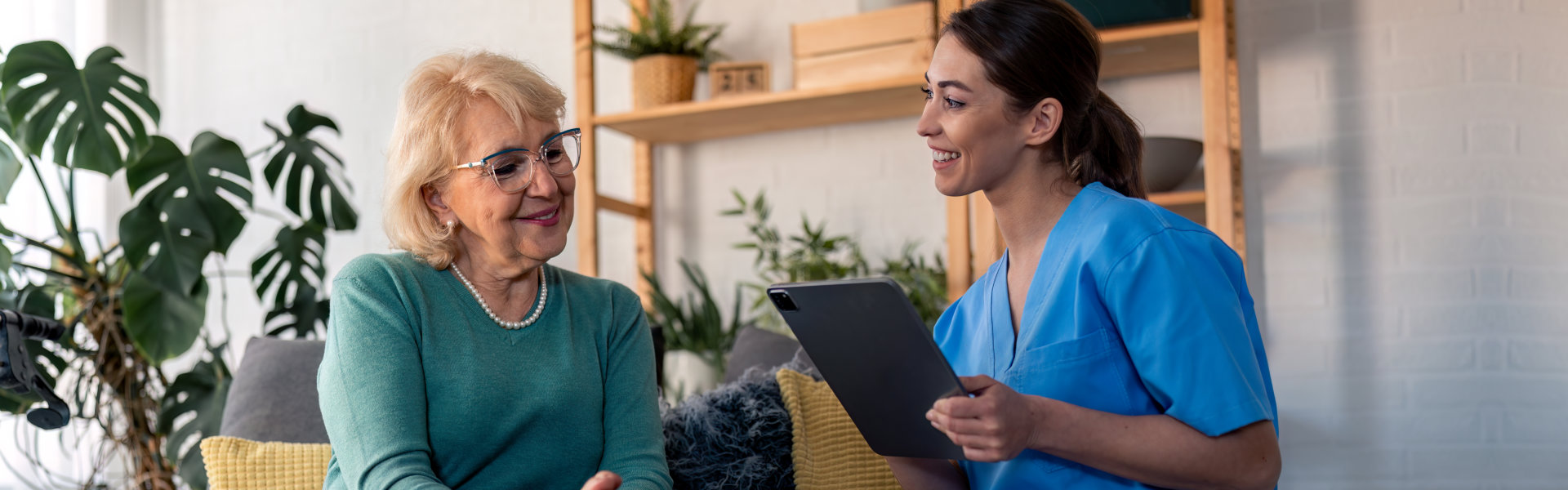 aide and senior woman having a conversation